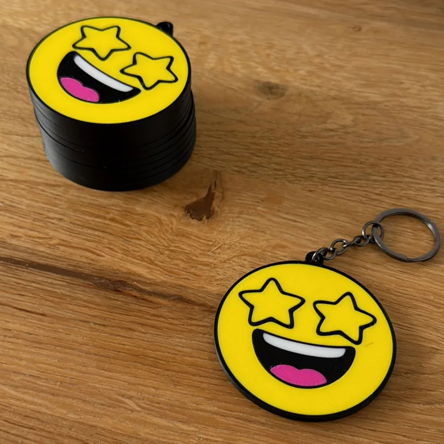 Gele 3D-geprinte smiley sleutelhanger met sterrenogen